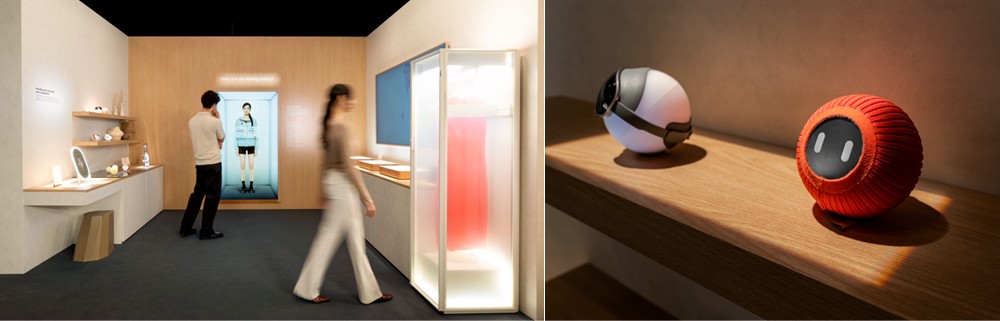 A imagem mostra os cenários da exposição 'Design is an act os Love" nas zonas Wearable Intelligence e Culinary Intelligence, com a presença de produtos como o Spatial Signage e o AI Beauty Mirror.