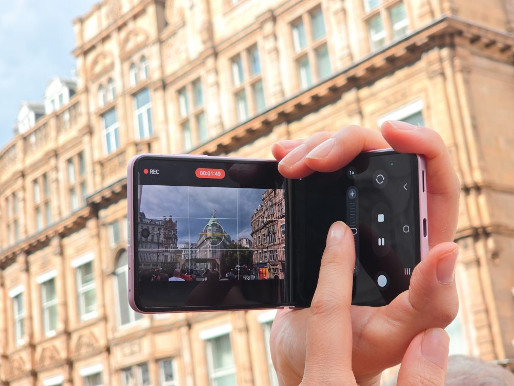 Close-up of a Samsung Galaxy foldable smartphone recording video in landscape orientation on a London street.