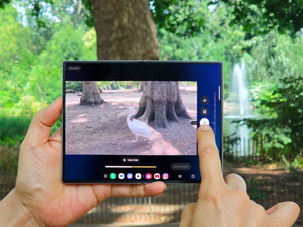 Close-up of an unfolded Samsung Galaxy foldable smartphone using Audio Eraser on a video recorded in a green London park.