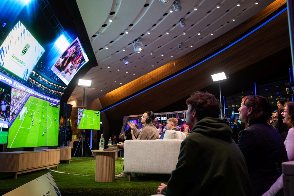 Fans watch as Team Germany and Team France compete on stage at Samsung OLED FC.
