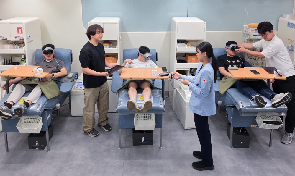Samsung employees use Galaxy XR while donating blood during the campaign at Samsung Digital City.
