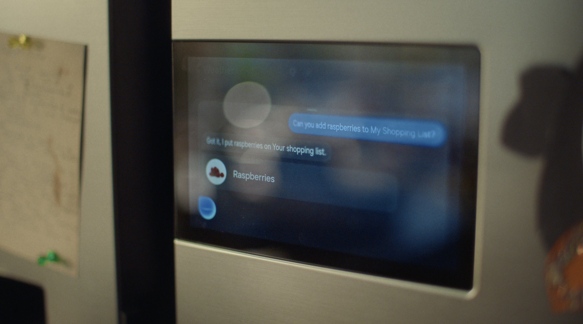 A smart refrigerator in a modern kitchen, part of Samsung's AI Home campaign.